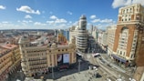 A bustling city street filled with diverse architecture.