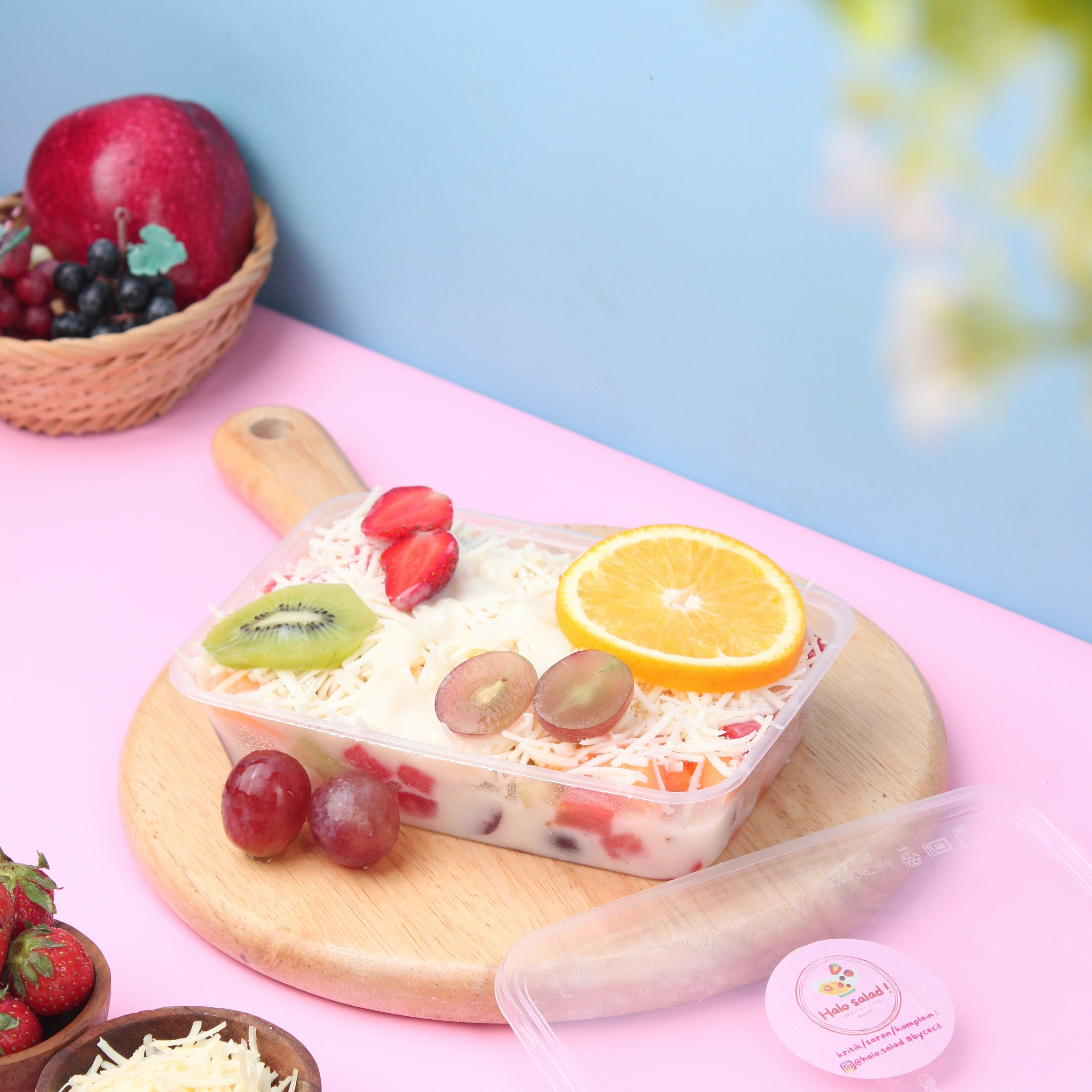 a bowl of fruit is sitting on a cutting board