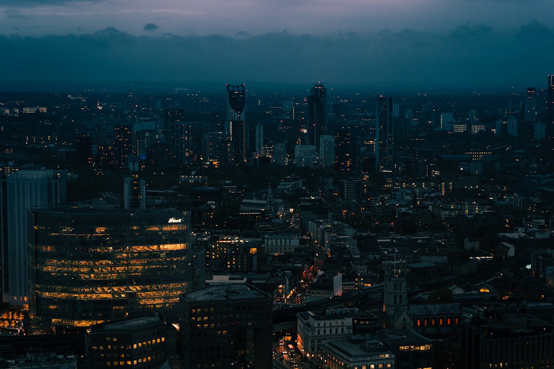 a view of a city at night from the top of a building, London skyline seen from the Skylounge in London, UK.