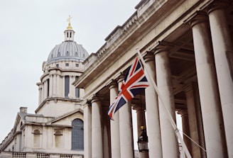 a british flag flying in front of a building