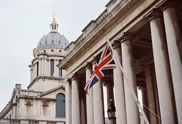 a british flag flying in front of a building