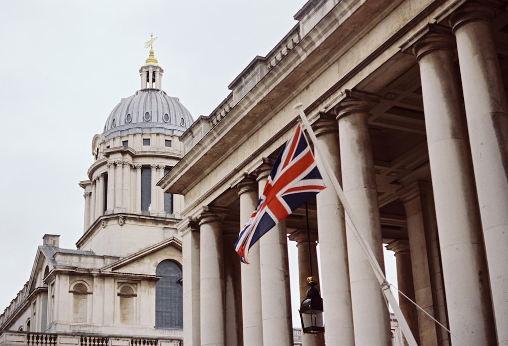 a british flag flying in front of a building