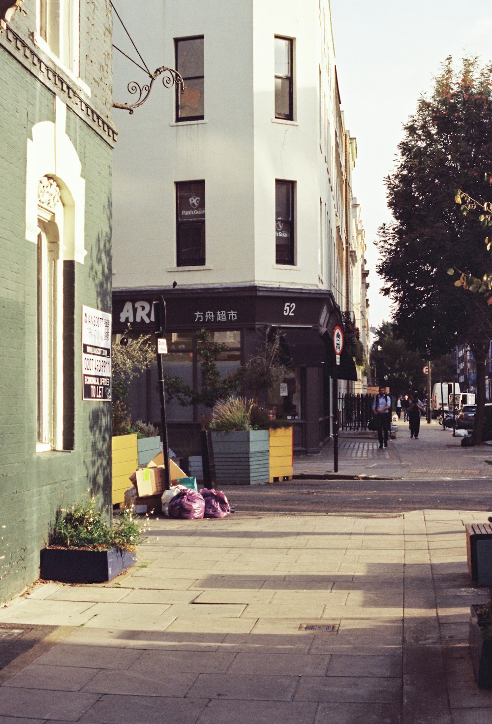 a city street with a building on the corner