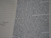A close-up photograph of a page from a book, likely a religious text, featuring dense printed text on the right side. The left margin contains lined spaces for notes, where a few handwritten words are visible. The text includes a passage with verses speaking about future events and prophecies.