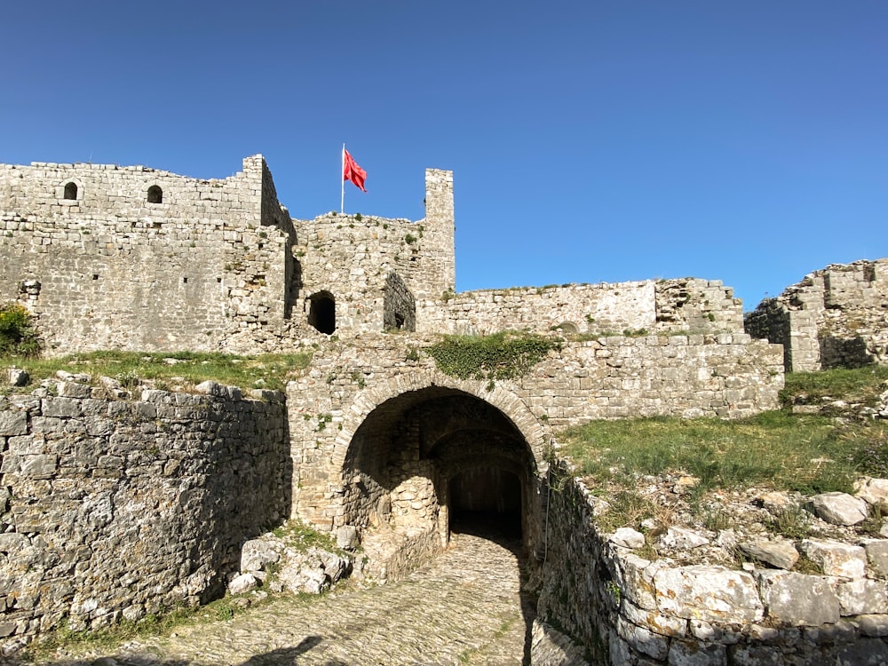 a stone castle with a flag on top of it