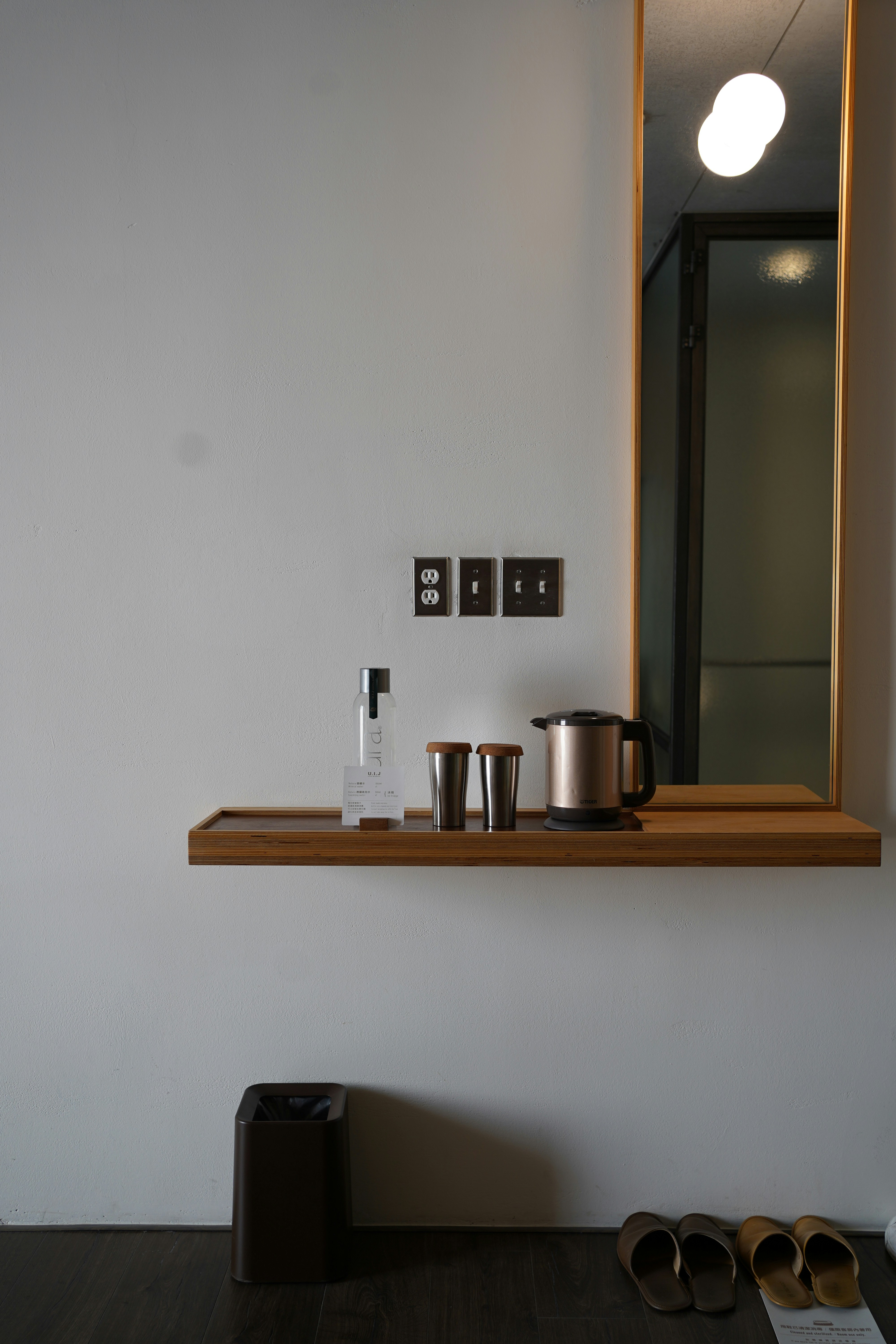 a bathroom with a sink, mirror and a shelf