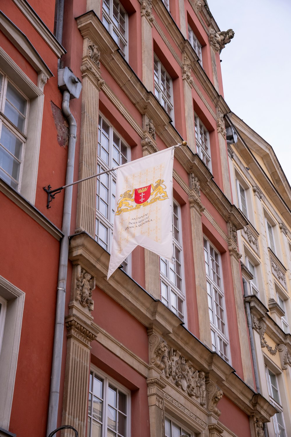 a building with a flag hanging from the side of it
