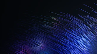 A dynamic parallax starfield with glowing violet data shards floating delicately.