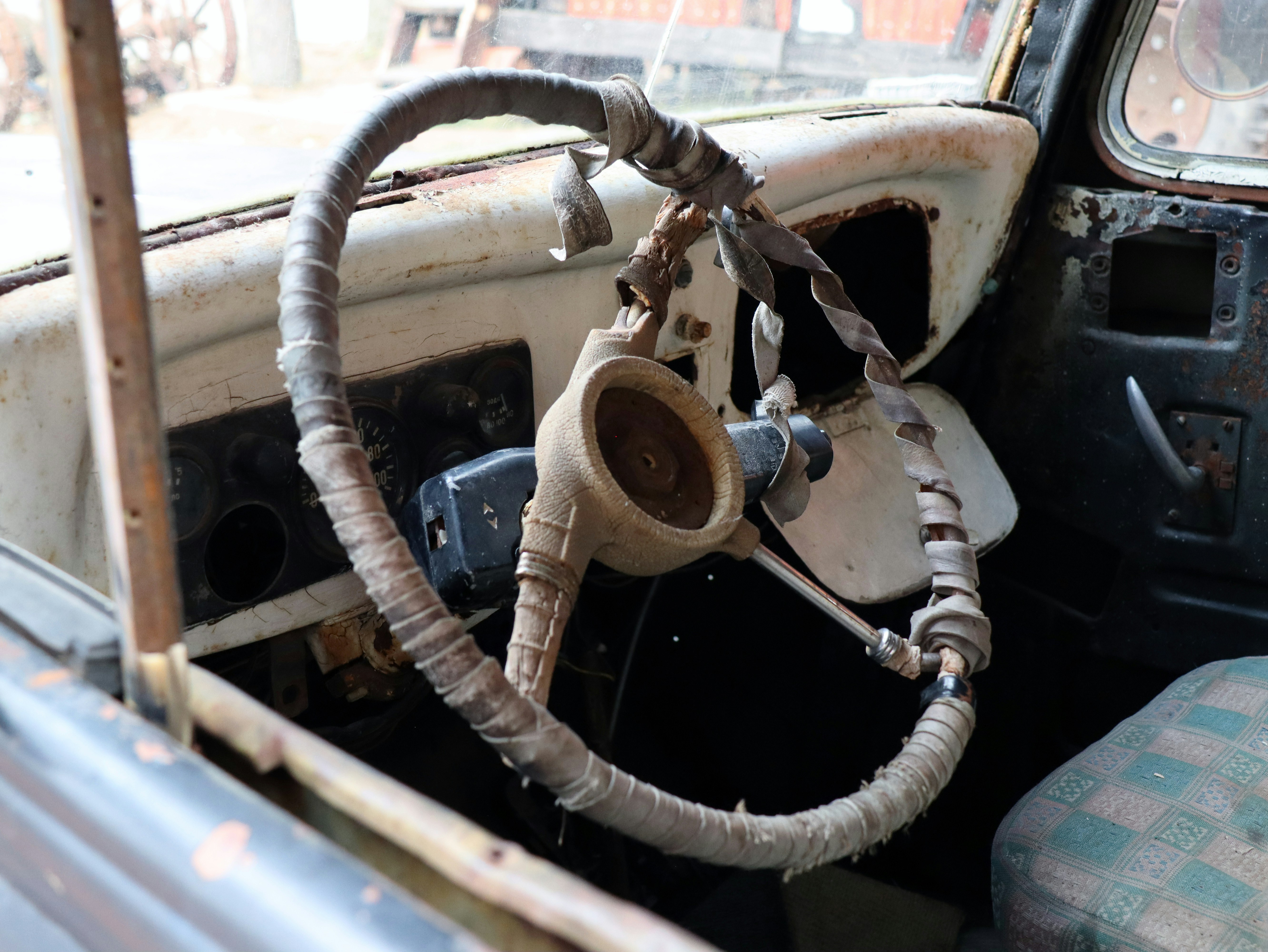 the interior of an old car with a steering wheel