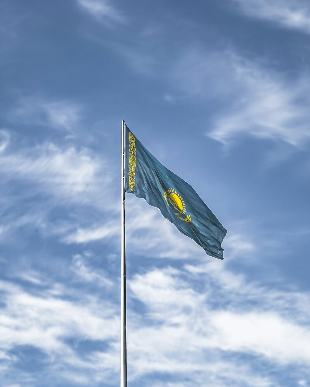 a flag flying high in the blue sky