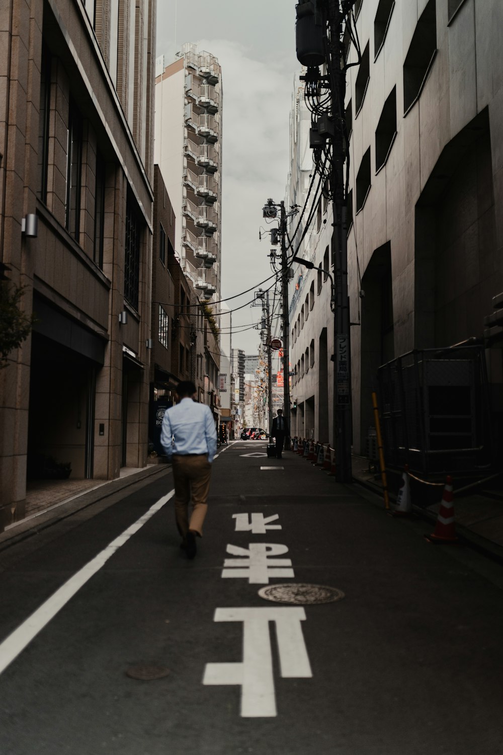 a man walking down a street with a backpack