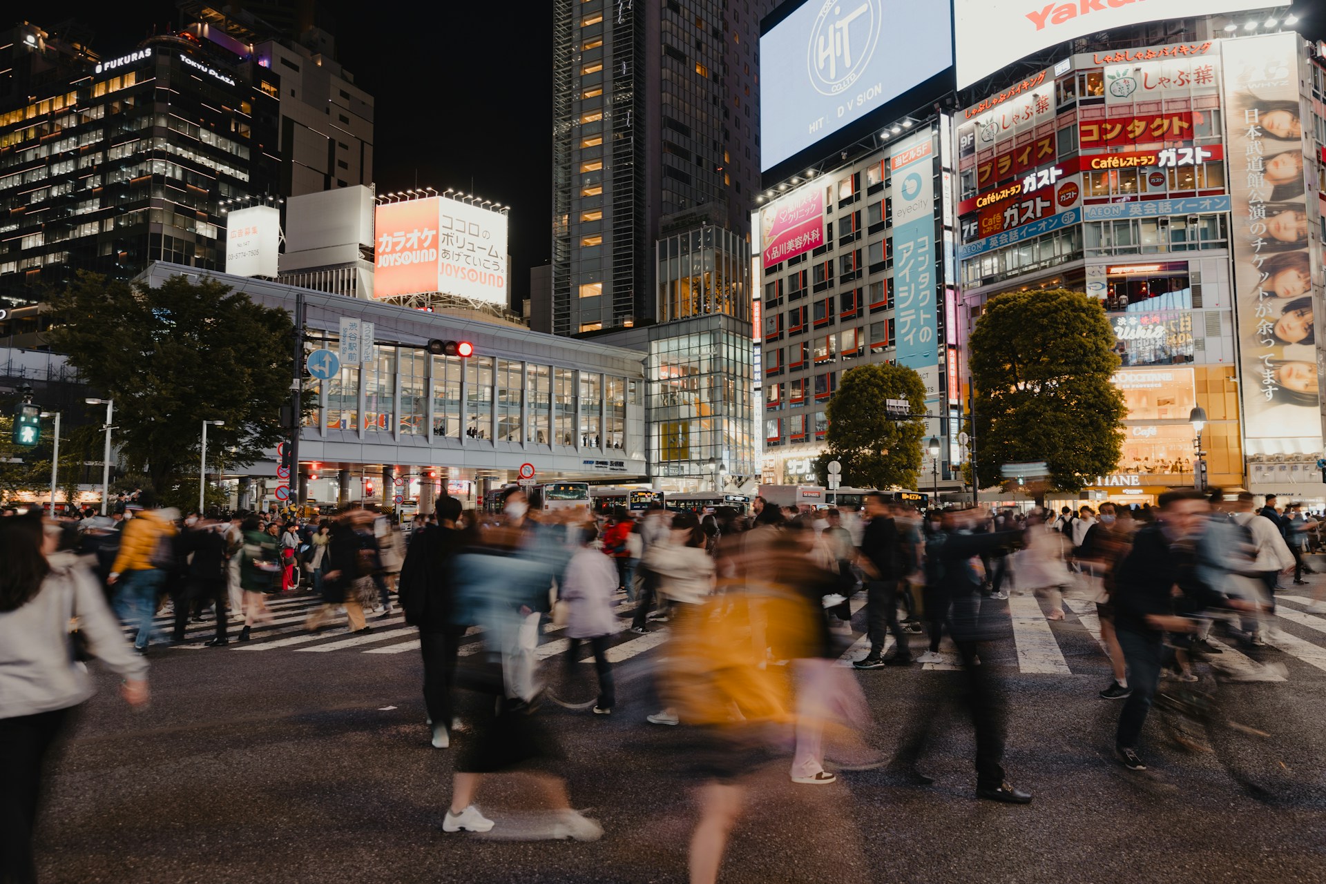 An urban street scene showcasing vibrant colors and dynamic movement of everyday life.