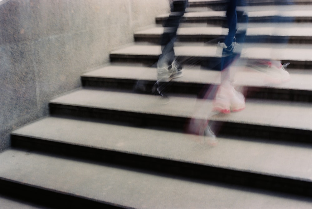 a blurry photo of a person walking down some stairs