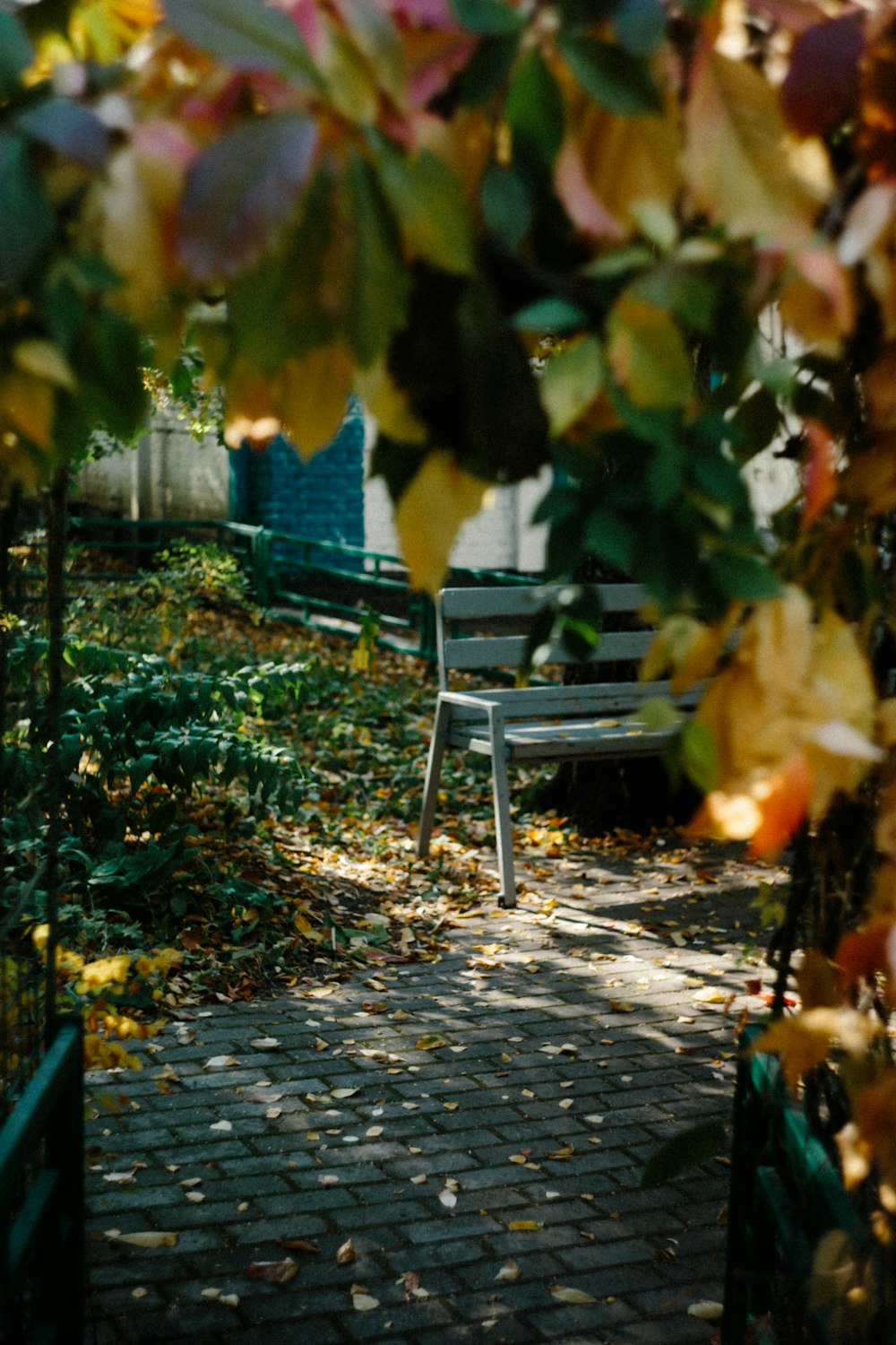 a white bench sitting on top of a brick walkway