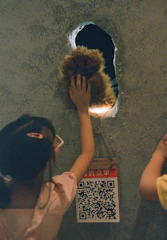 Children exploring a colorful sensory wall filled with textures and lights.