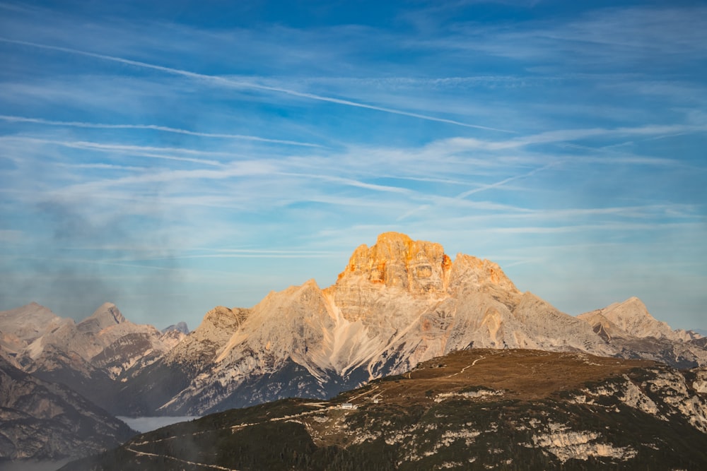 a view of a mountain range with clouds in the sky