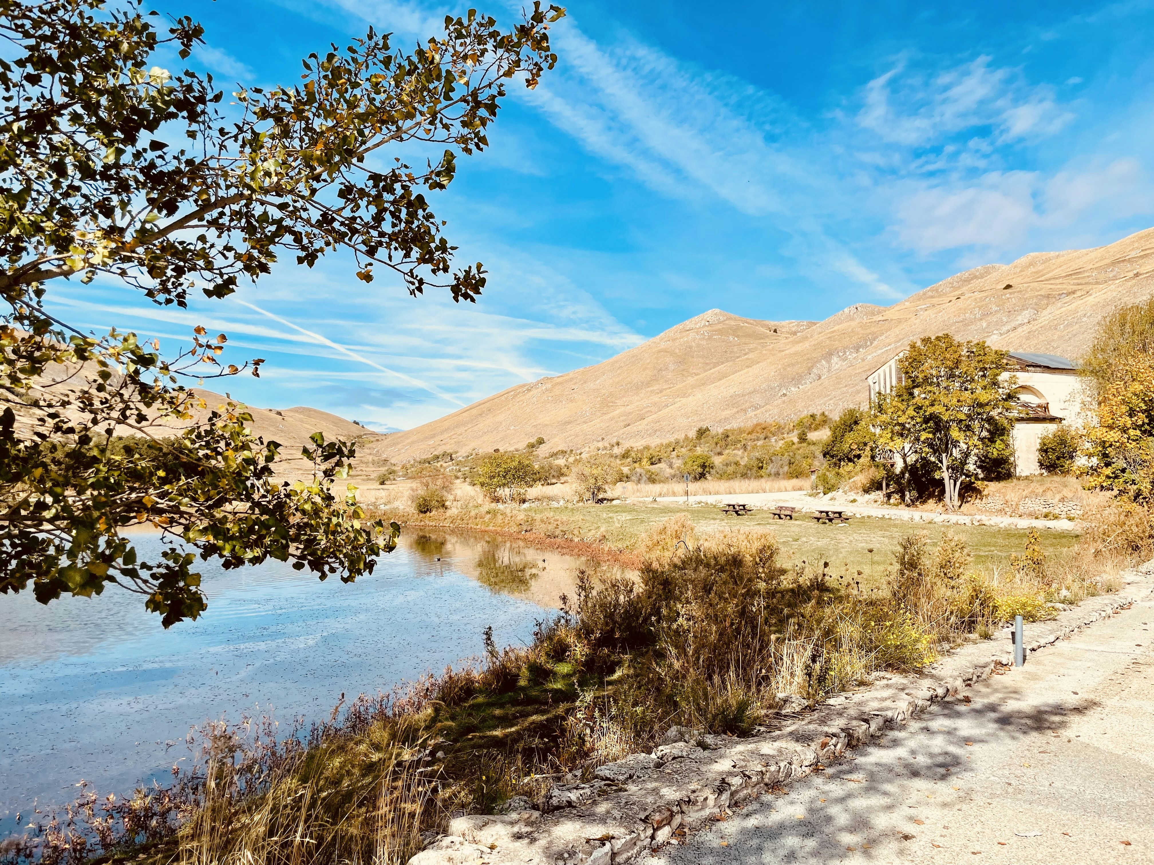 a river running through a lush green hillside