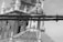 A detailed focus is placed on a bundle of wires or cables that cross horizontally in the foreground, while a blurred background features an ornate architectural structure with columns and a domed roof.