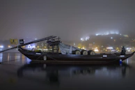 A traditional boat gliding along the calm waters of the Zambezi River at twilight.