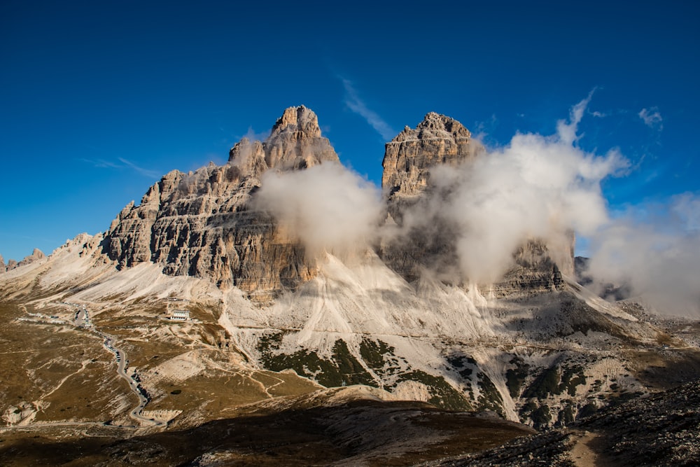 a group of mountains with clouds in the sky