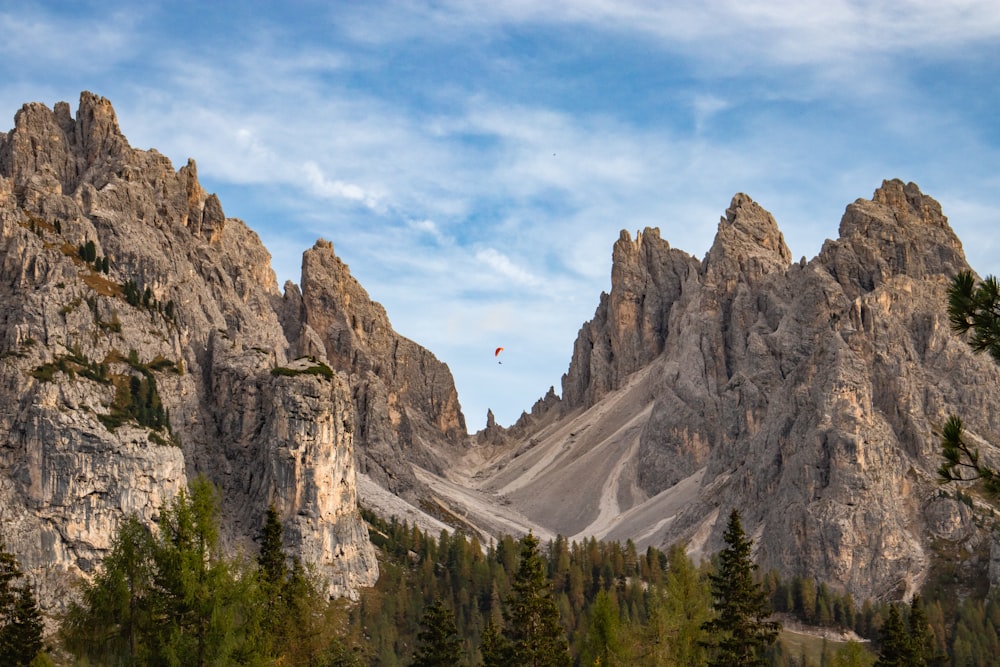 a group of mountains with trees in the foreground