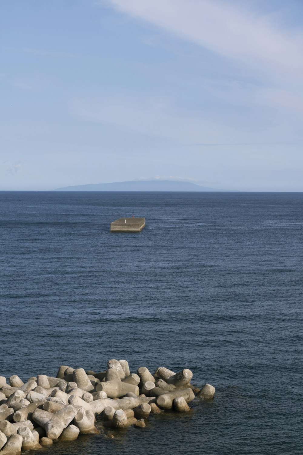 a boat is out on the water near rocks