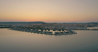 A stunning view of a waterfront property at sunset.