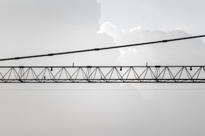 Industrial crane lifting heavy materials with a backdrop of steel structures.