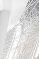 Close-up of steel beams intersecting in a modern commercial building under construction.