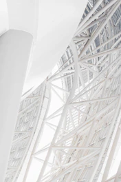 A striking architectural close-up of intersecting steel beams symbolizing structural precision and strength.