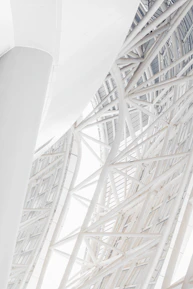 Close-up of steel beams arranged in a modern architectural framework.