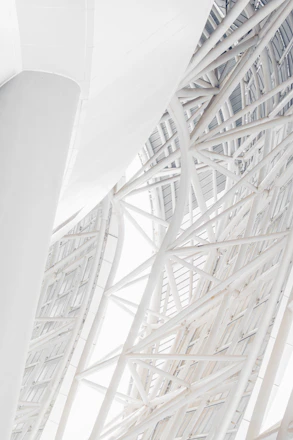 A striking architectural close-up of intersecting steel beams symbolizing structural precision and strength.