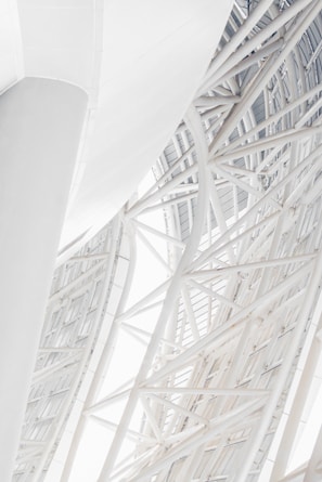 Close-up of steel beams intersecting in a modern commercial building under construction.