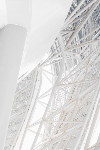 Close-up of steel beams arranged in a modern architectural framework.