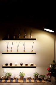 A collection of compact diffusers and humidifiers displayed on a wooden shelf
