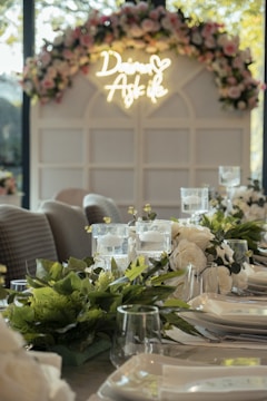 An anniversary celebration table set with candles and flowers.