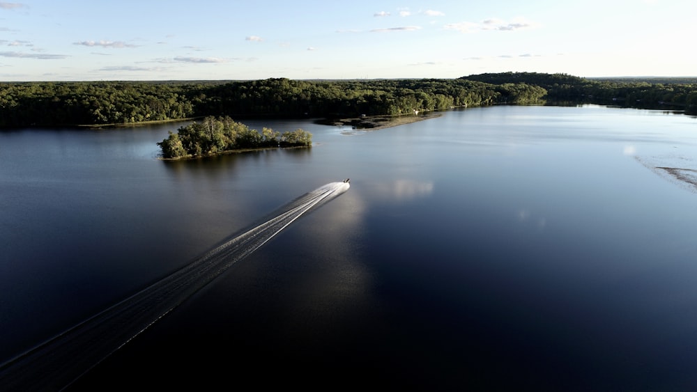 an aerial view of a boat on a lake