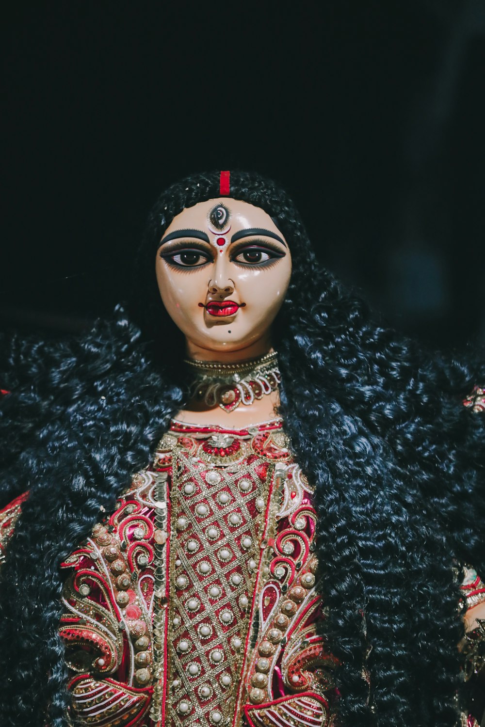 a close up of a doll with long hair