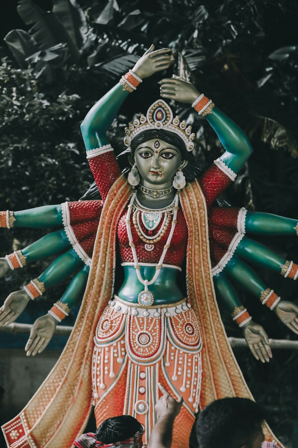 a statue of a woman in a red and green outfit