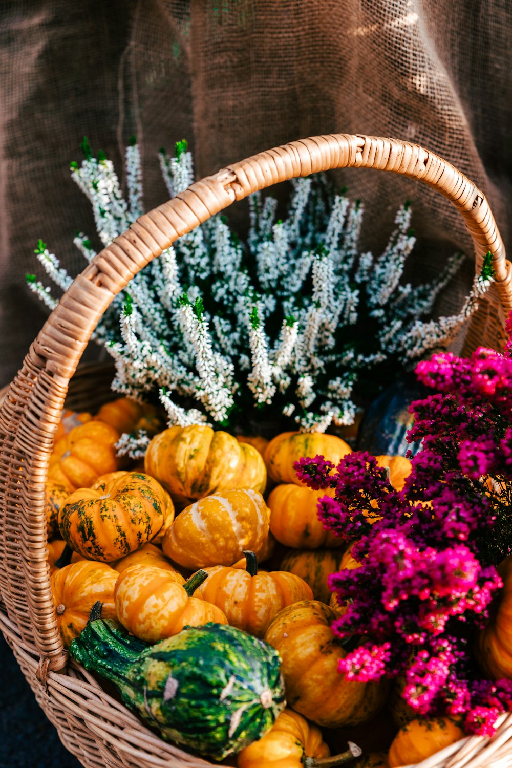 a basket filled with lots of different types of flowers