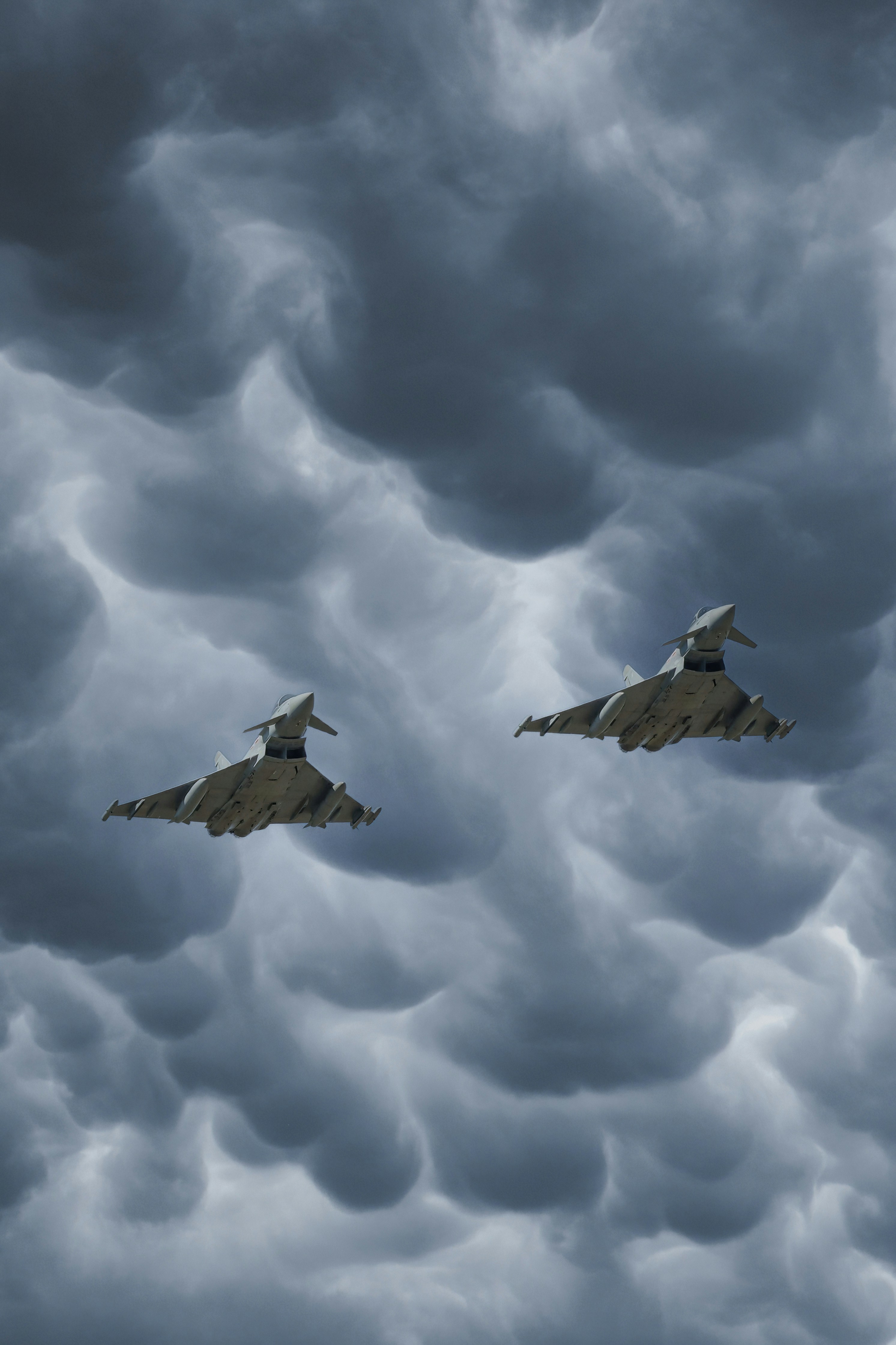 Two fighter jets flying through a cloudy sky photo – Free Wallpaper ...