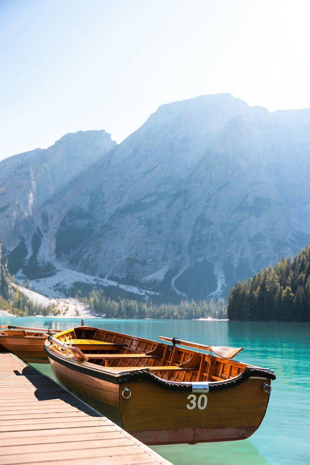 a couple of boats sitting on top of a lake