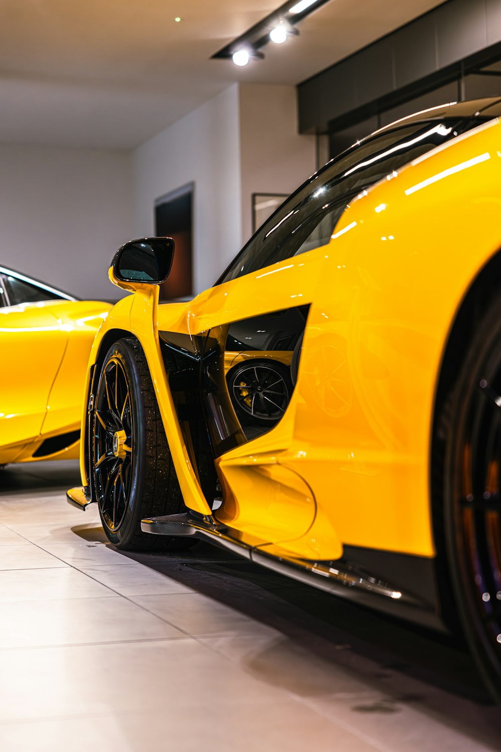 a yellow sports car parked in a garage