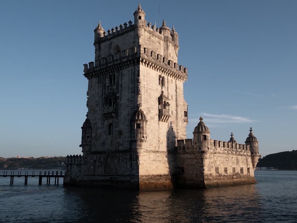 a tall tower sitting on top of a body of water