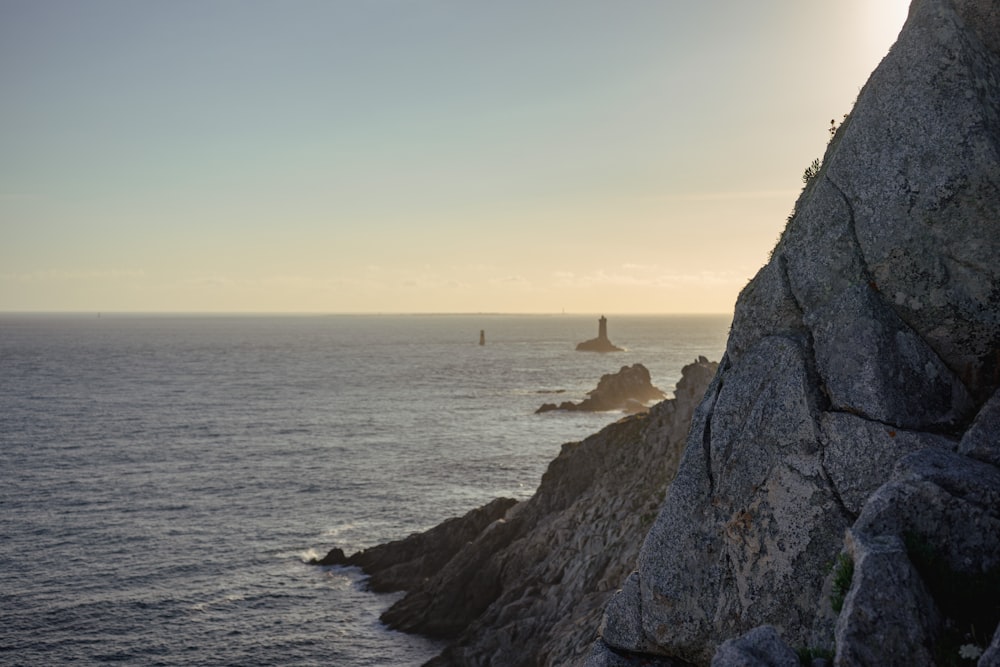 a person standing on the edge of a cliff overlooking the ocean