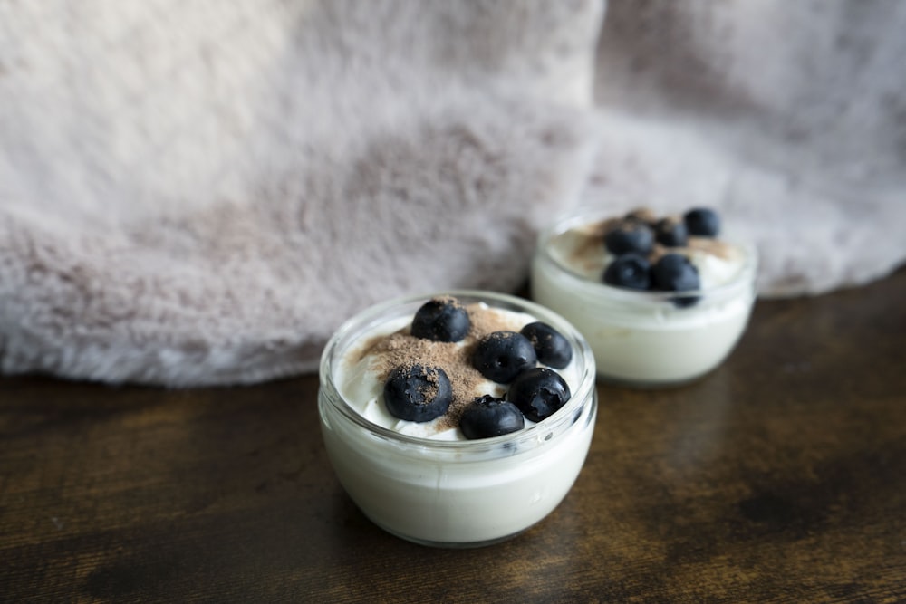 a couple of small bowls of food on a table