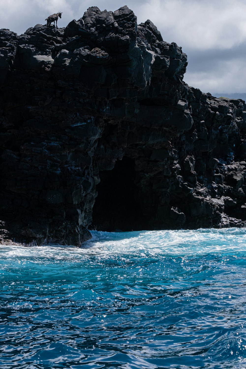 a rocky outcropping with a cave on top of it