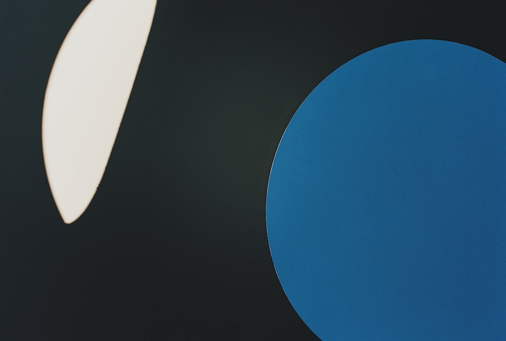 a blue circle and a white circle on a black background