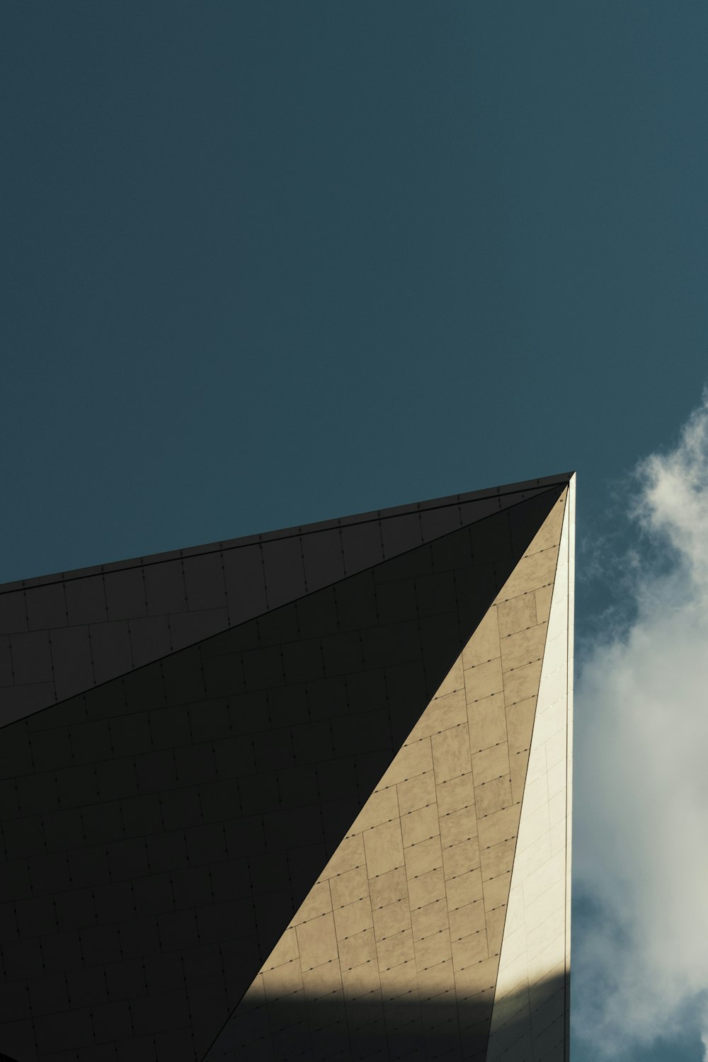 a plane flying in the sky over a building