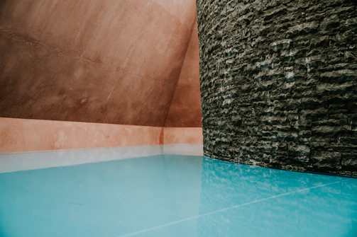 A clean cistern interior showing a fresh white waterproof coating with blue indigo accents.